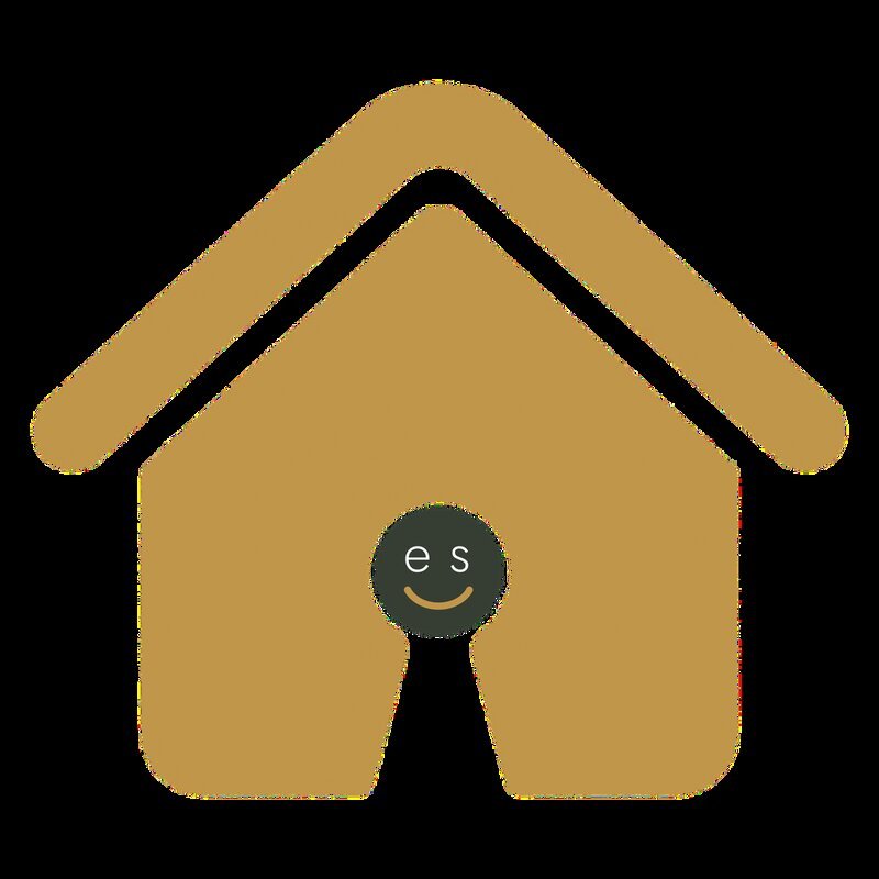 A golden house icon with a keyhole shape at its centre, inside which sits a small circular logo featuring a smiley face and the letters 'e s', representing the Ease-See accommodation brand.